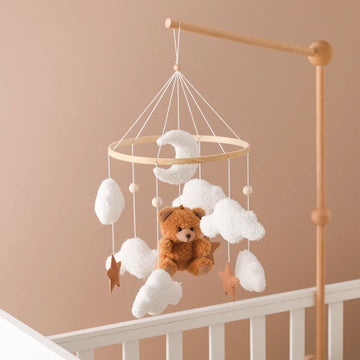 Wooden baby crib mobile with bell and hanging bracket.